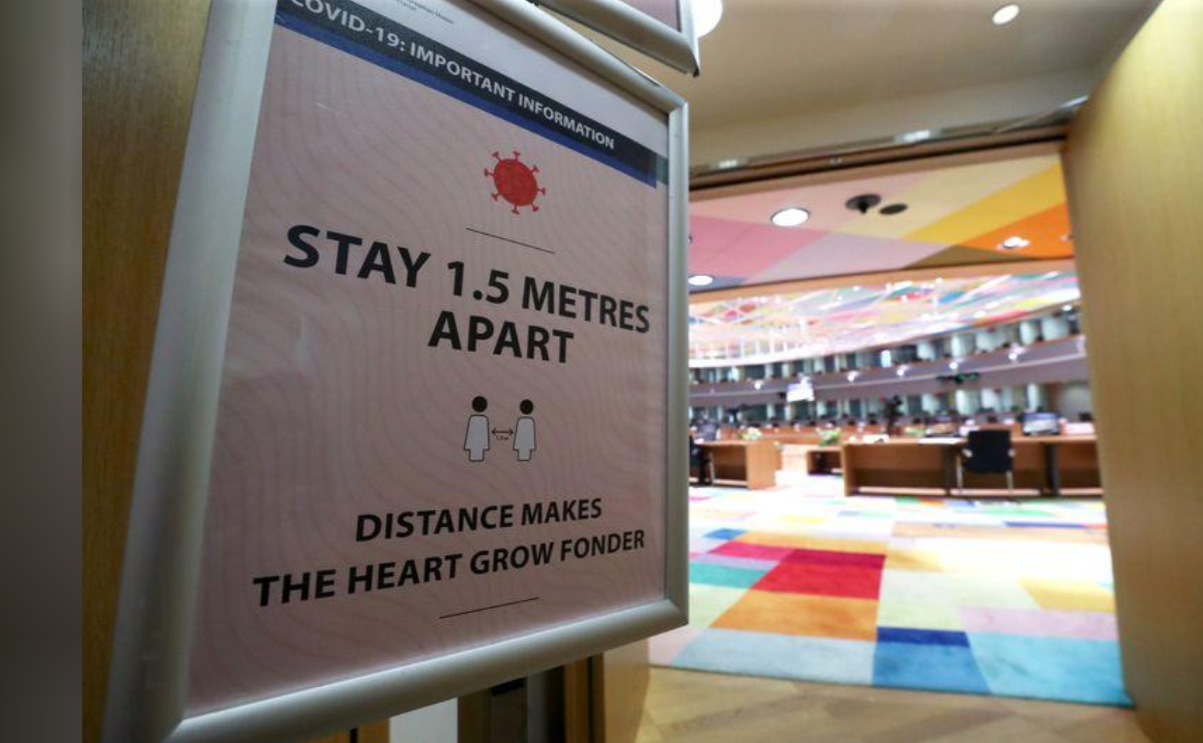 在当地时间7月16日召开的欧盟成员国领导人峰会会议室的入口处，竖立着“保持1.5m社交距离”的警示牌。（图源：路透社）.png